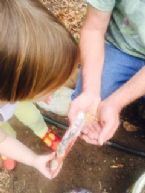 Noble and Daughter plant seeds