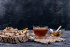 side view tea with ginger slices honey sack cloth dark wooden backgrou