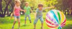 children playing outside with big balloon ball hero