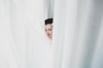 woman peeking between curtains 1304 145