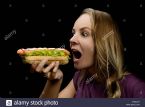 young girl eating a hotdog FXMCD7